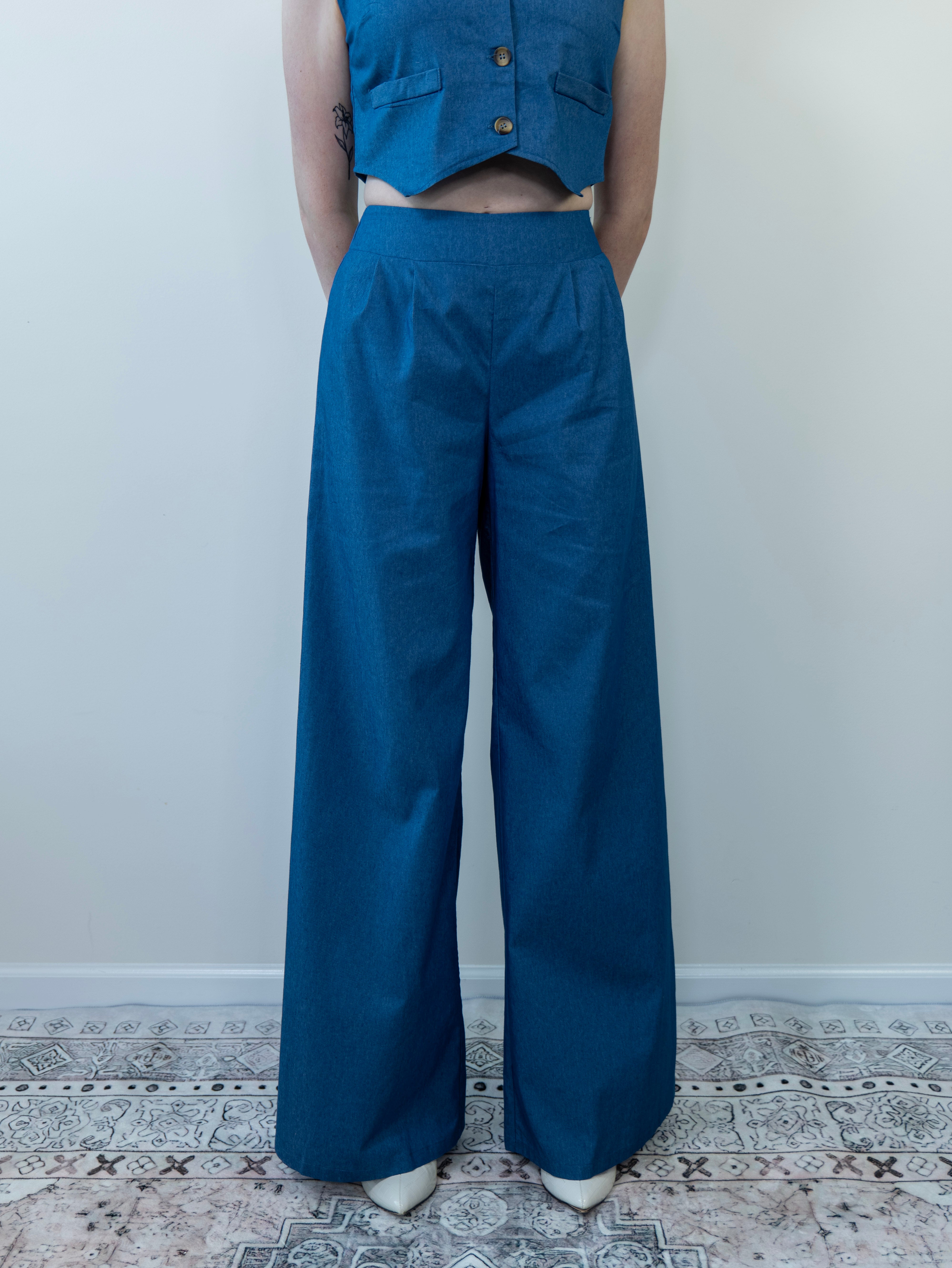 Model wearing denim-print vest, close-up from waist up