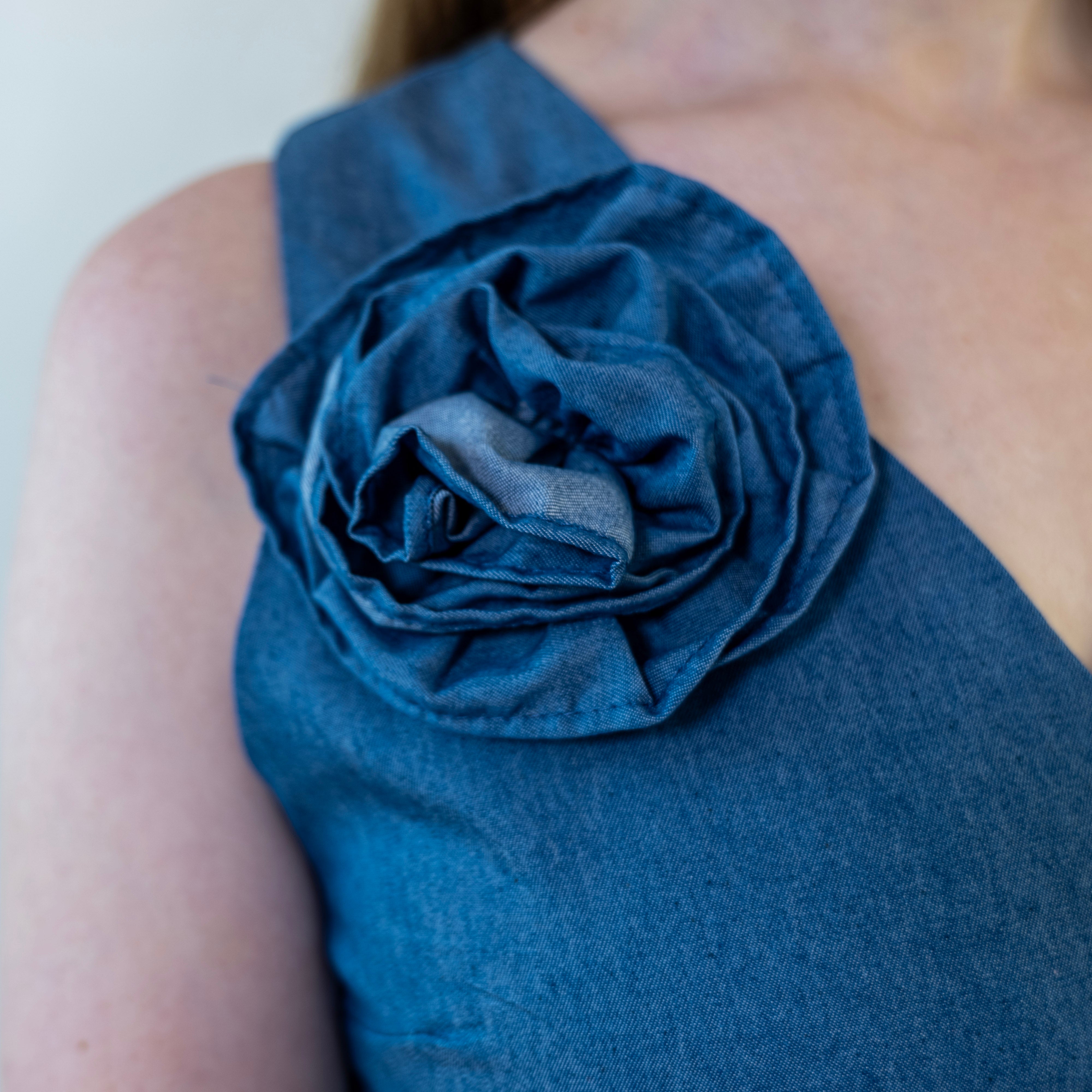 Close-up of removable denim-print flower accessory