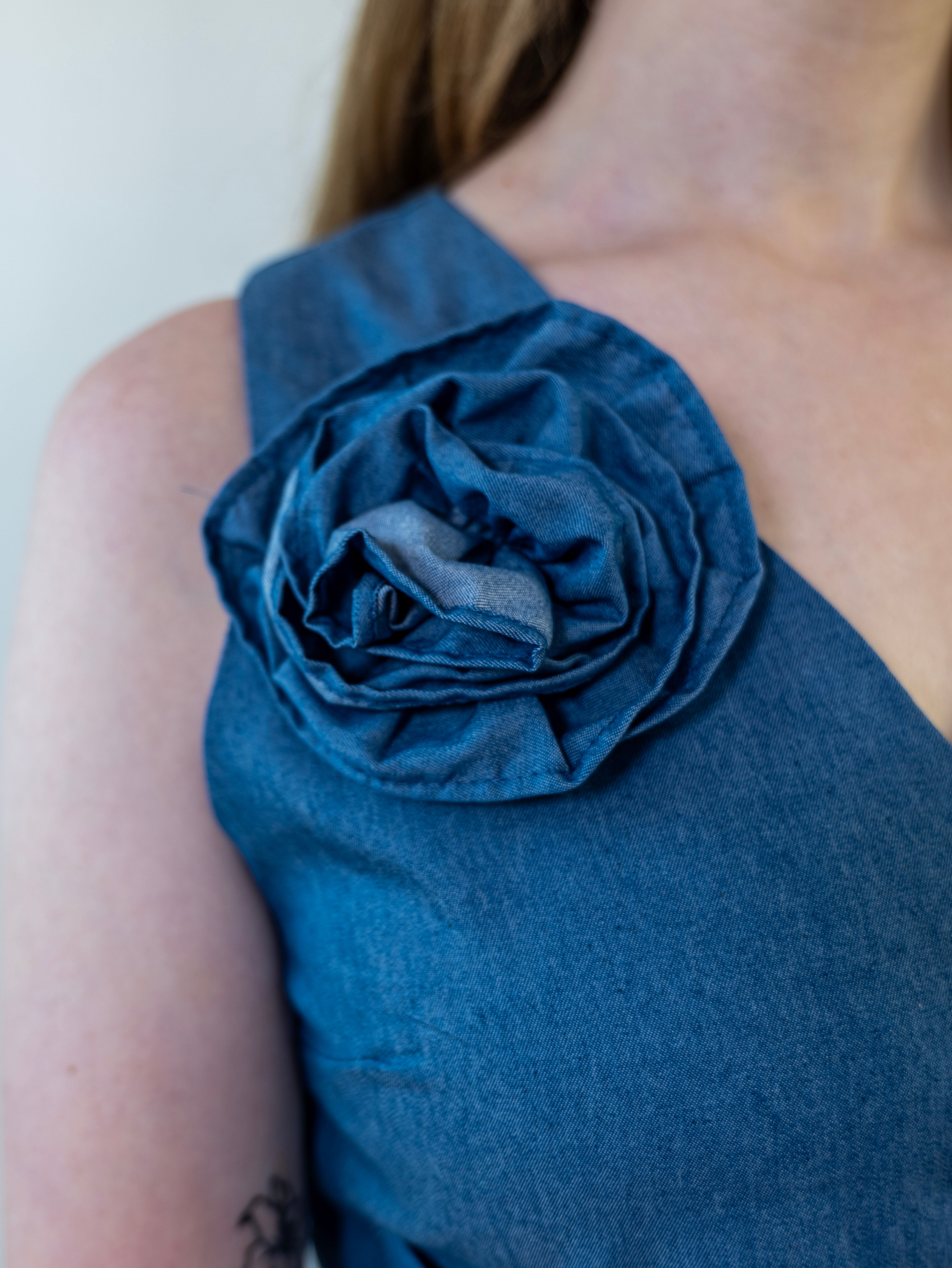 Close-up of removable denim-print flower accessory