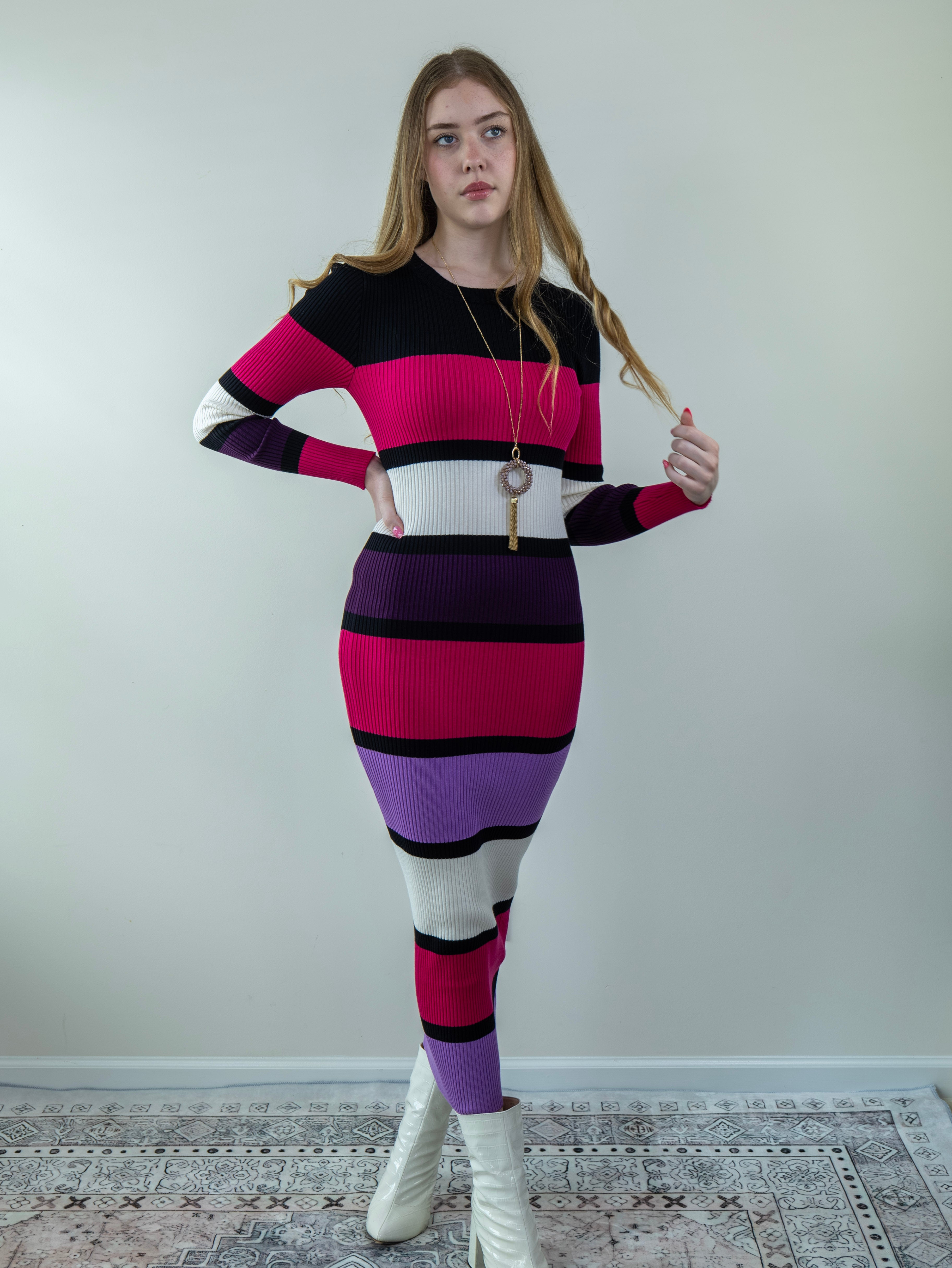 Model posing in multicolor ribbed midi sweater dress, showing right-side angle.
