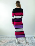 Back view of the color-block midi sweater dress, showing midi length and fitted silhouette.