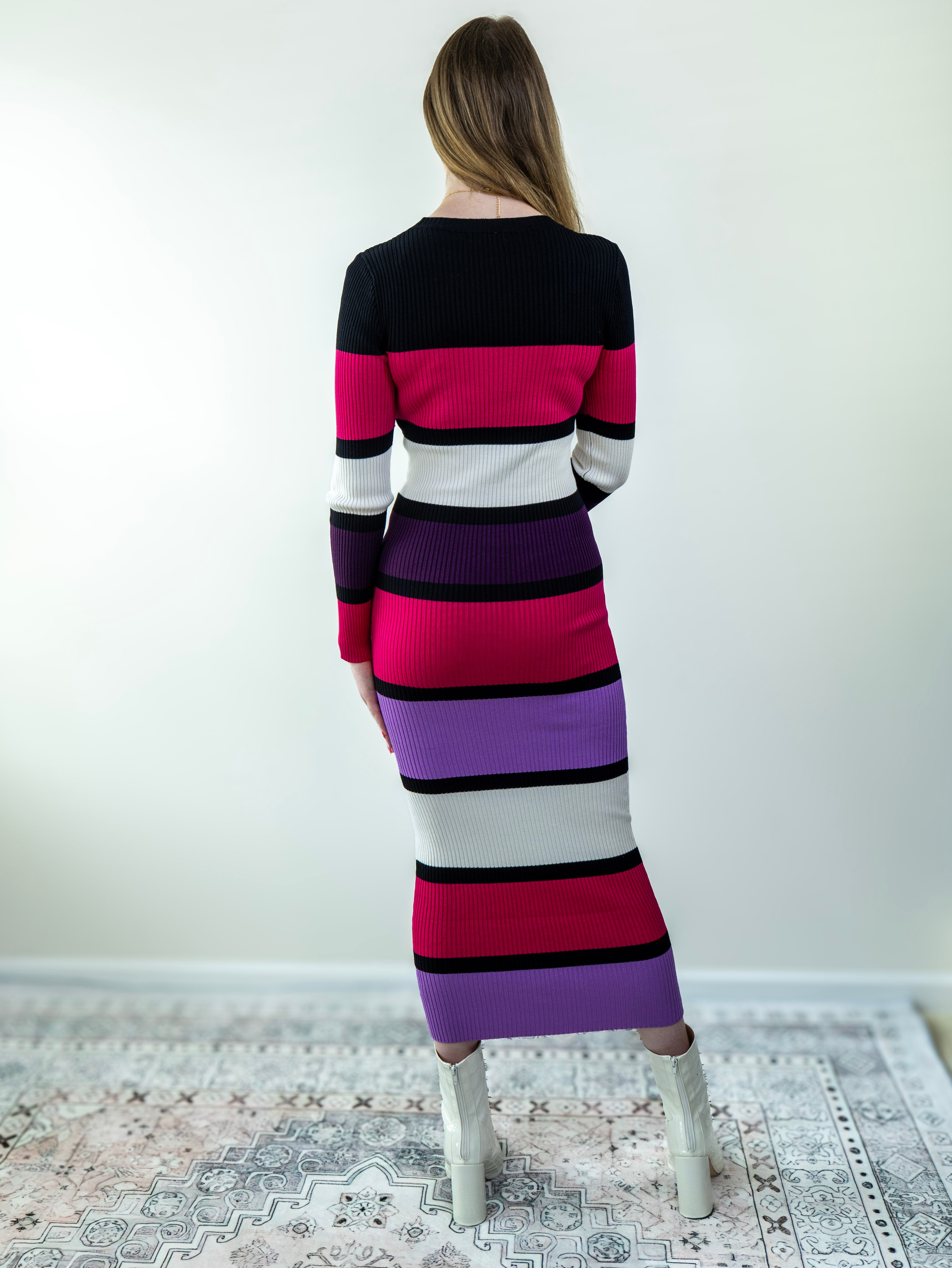Back view of the color-block midi sweater dress, showing midi length and fitted silhouette.