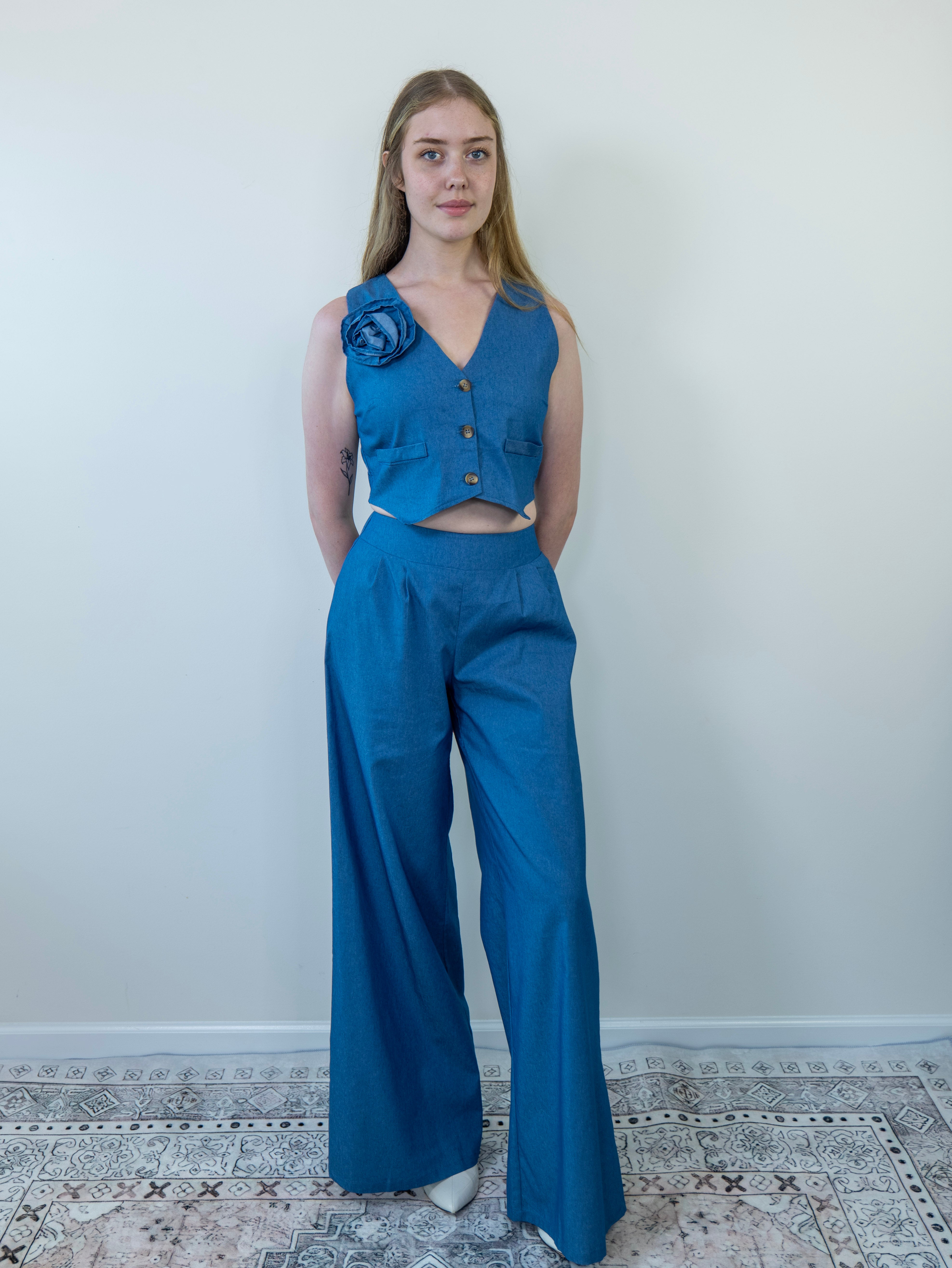 Model wearing denim-print sleeveless vest and wide-leg pants, front view