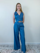 Model wearing denim-print sleeveless vest and wide-leg pants, front view