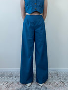 Model wearing denim-print vest, close-up from waist up
