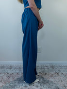 Model wearing denim-print pant set, side view