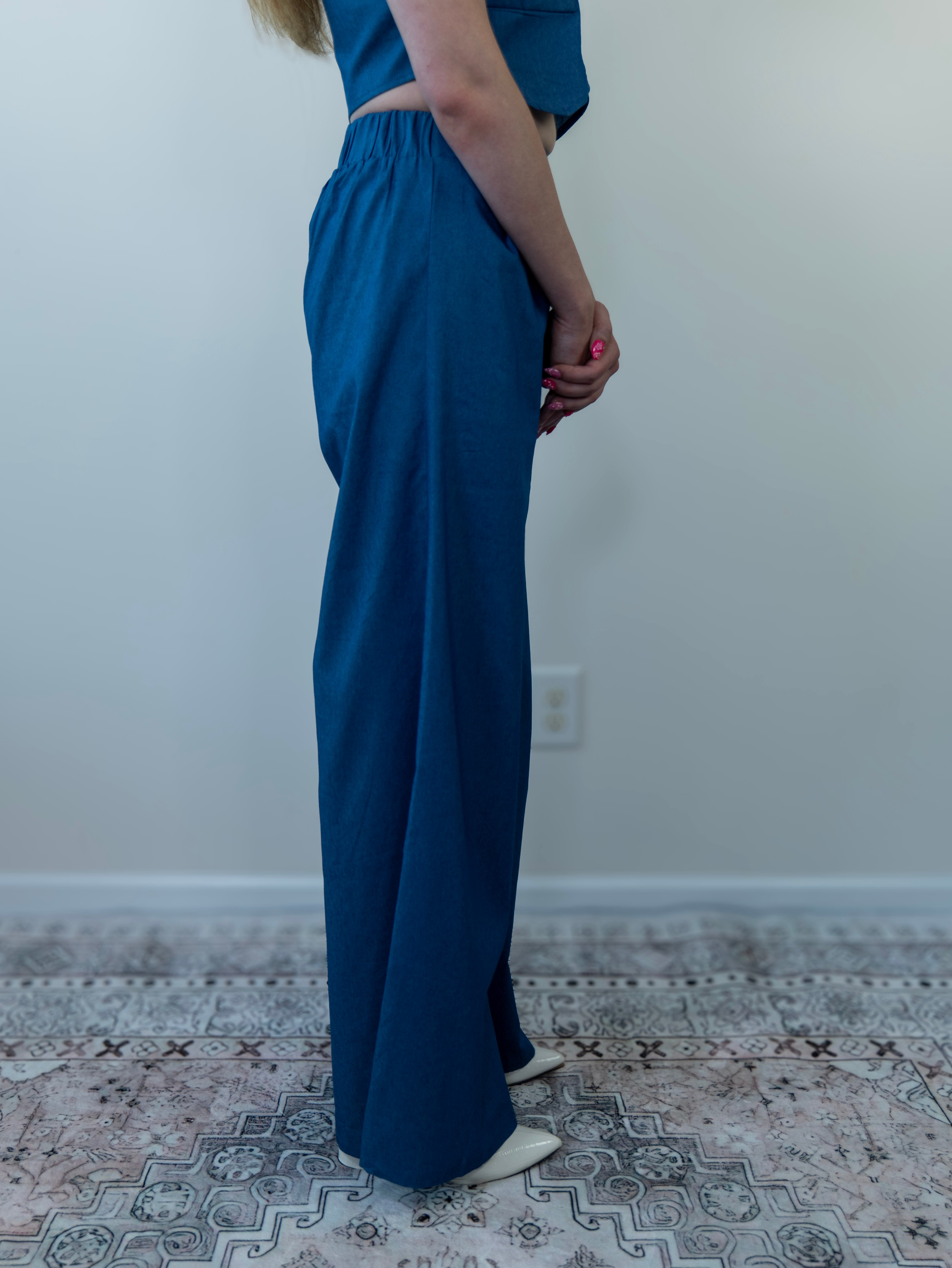 Model wearing denim-print pant set, side view