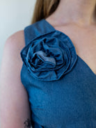 Close-up of removable denim-print flower accessory