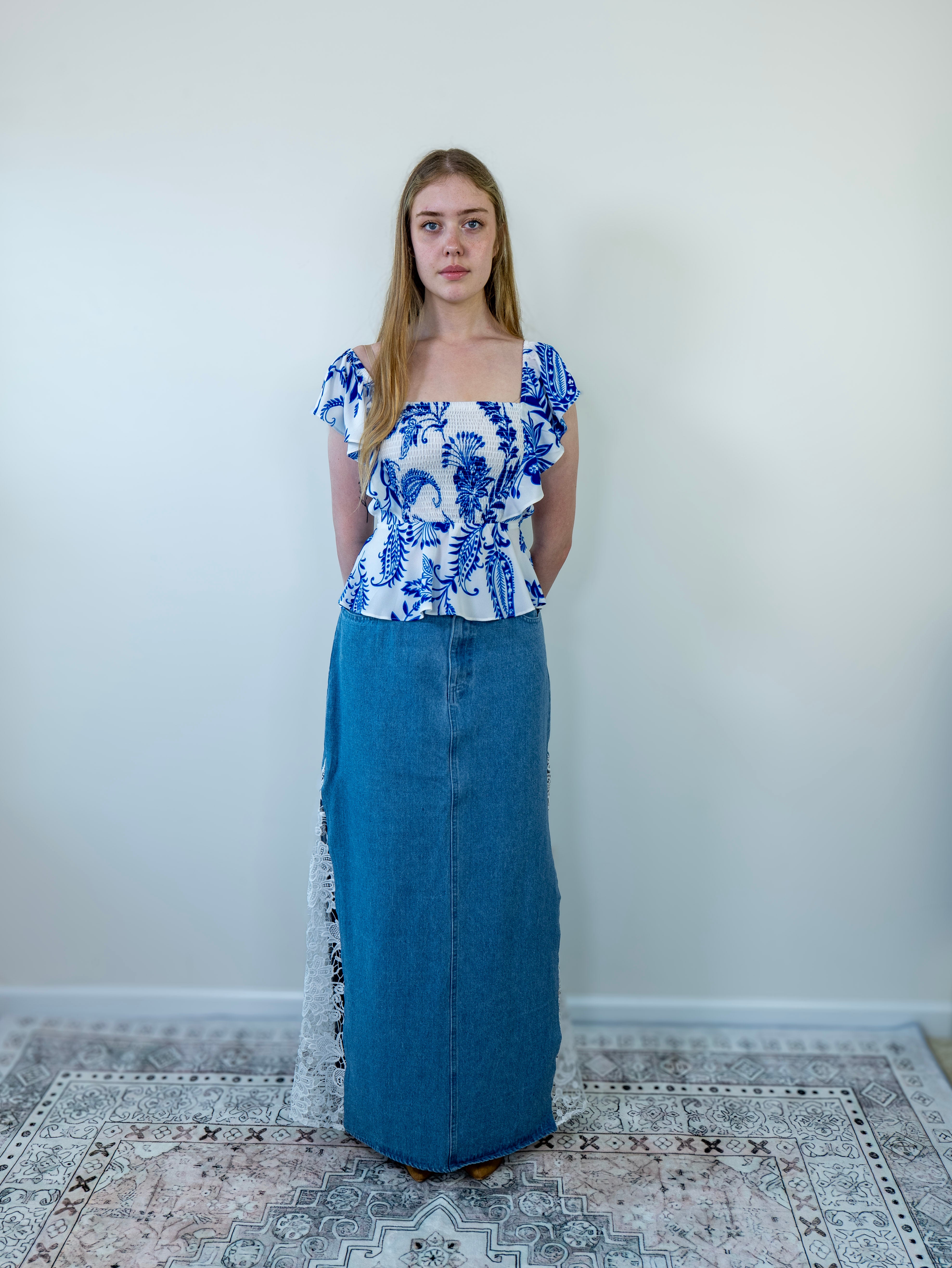 Model wearing a denim crochet maxi skirt, full-length front view.