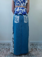 Back view of denim blue maxi skirt with crochet lace panel.