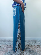 Model standing in denim blue crochet maxi skirt, angled front view