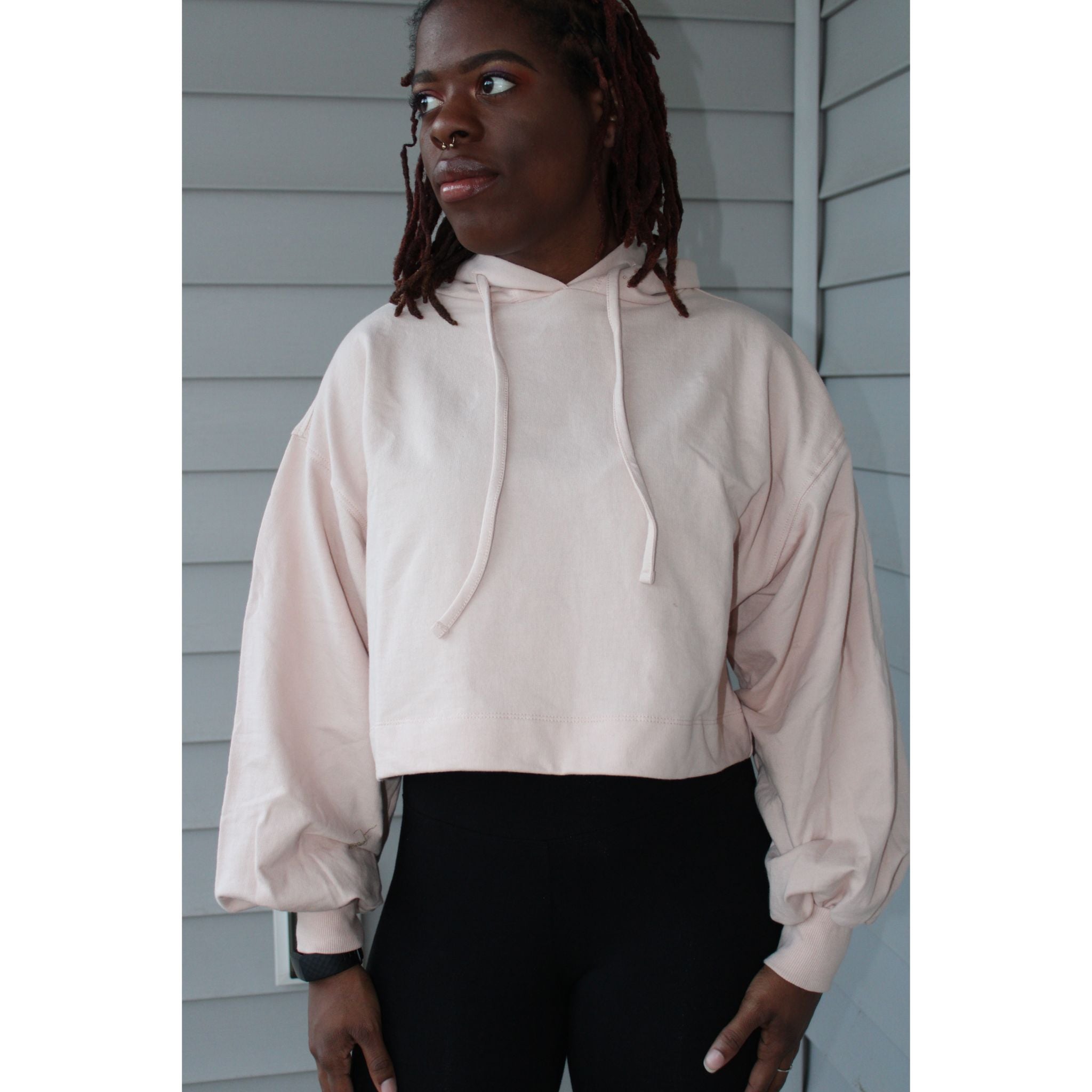 Dusty pink oversized cropped hoodie with balloon sleeves, thick drawstring, and 2-inch waistband for a relaxed, comfortable look. Model showing the  front of the crop hood top